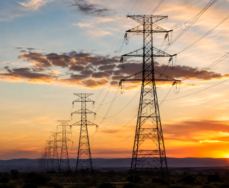 High-voltage transmission towers at sunset